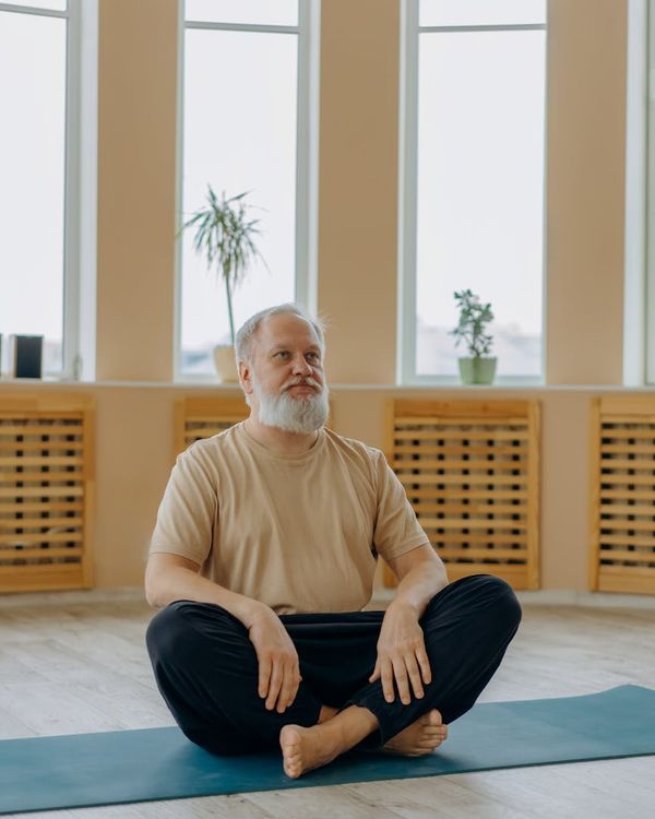 Person in a comfortable sitting position, feeling balanced and calm.